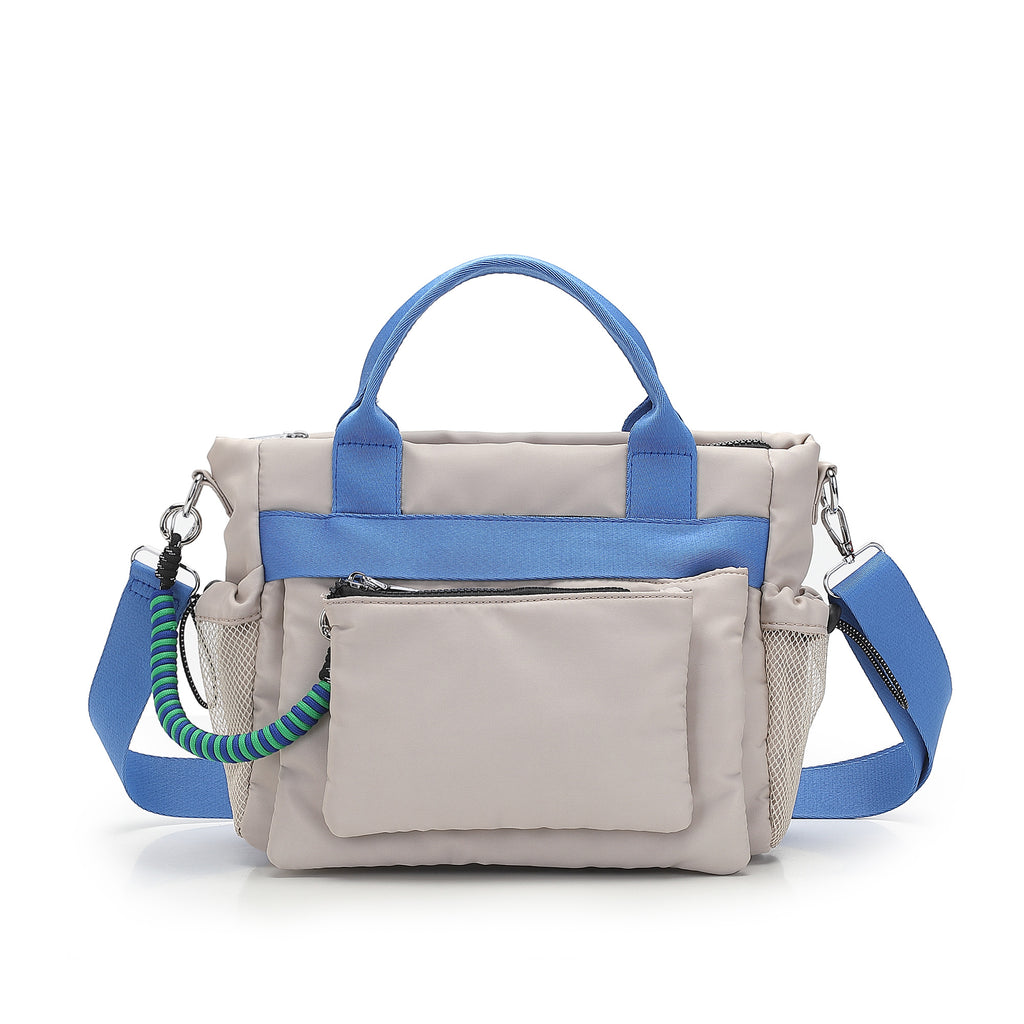 Gray handbag with blue straps on a white background