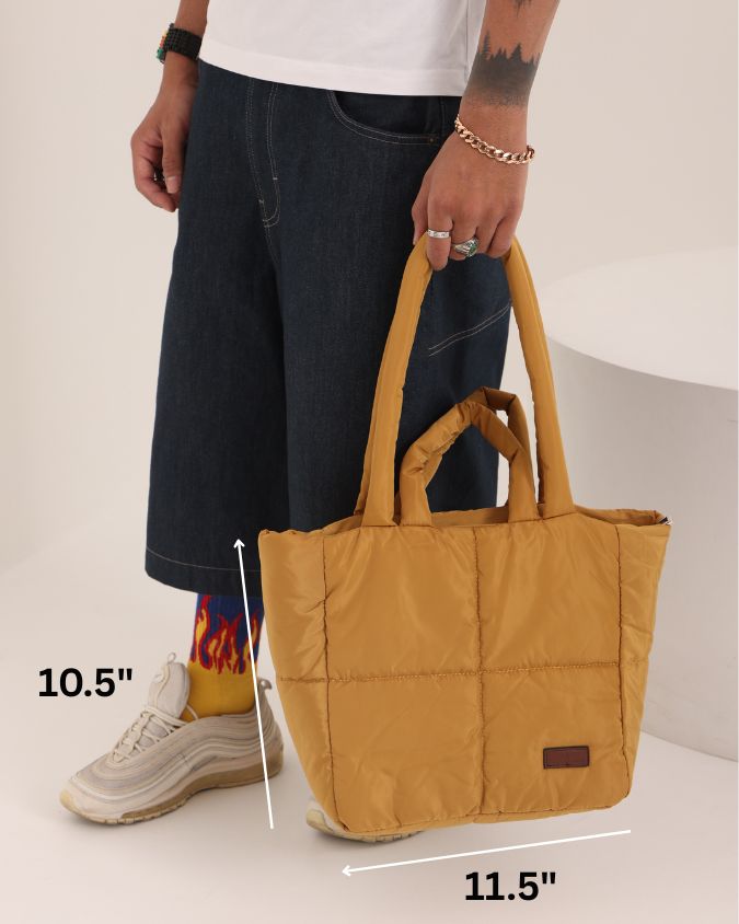 Stylish quilted puffer tote bag with padded handles and box-stitched detailing – ultra-lightweight, roomy, and perfect for everyday use. Ideal for college, shopping, or casual streetwear looks. A trendy fashion essential from Tales of Totes, offering cozy-chic appeal beyond standard canvas bags on Indian platforms like Myntra, Flipkart, and Amazon."