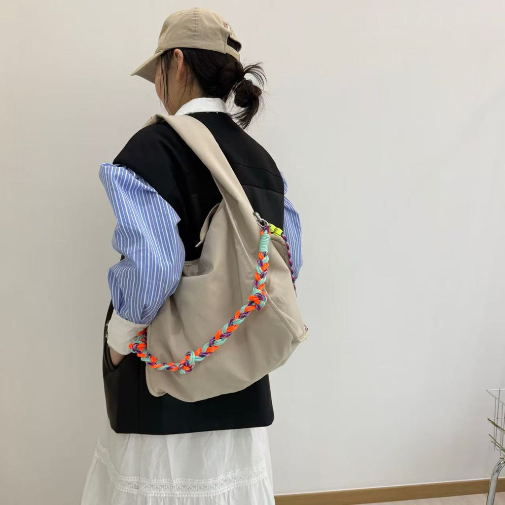 Waterproof nylon hobo bag with wide shoulder handle, removable braided crossbody strap and detachable mini pouch
