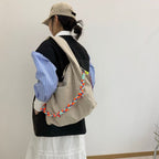 Waterproof nylon hobo bag with wide shoulder handle, removable braided crossbody strap and detachable mini pouch