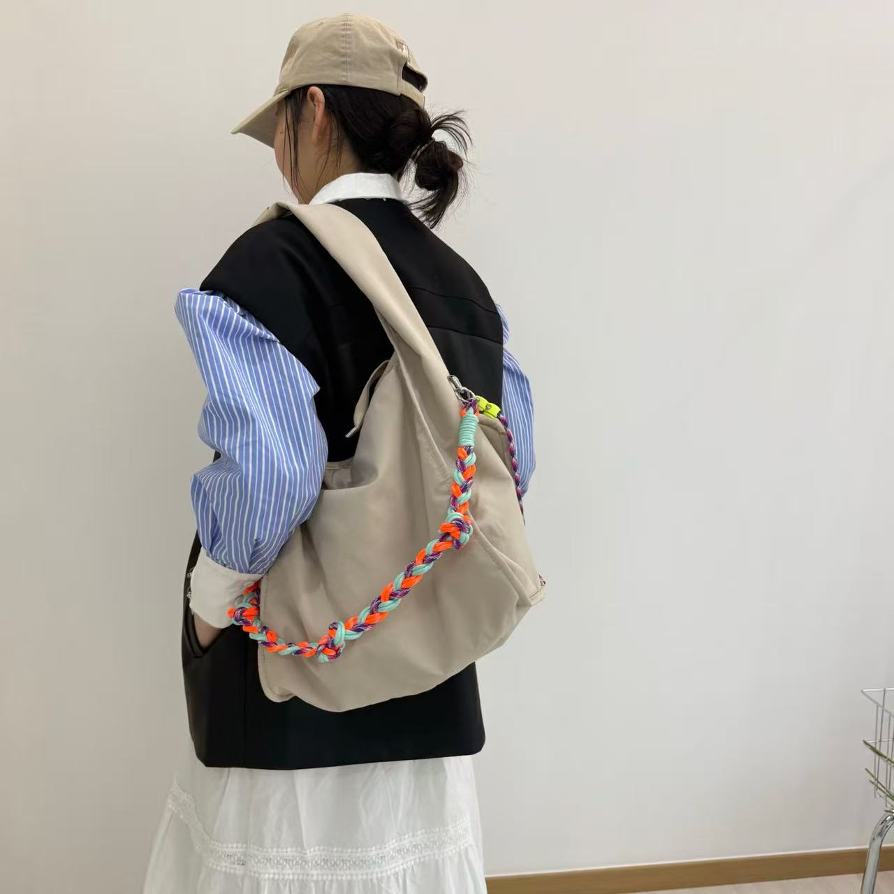 Waterproof nylon hobo bag with wide shoulder handle, removable braided crossbody strap and detachable mini pouch