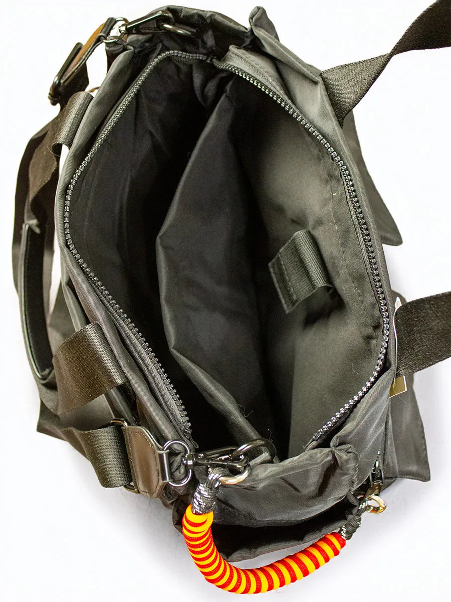 Open green bag with a coiled orange and yellow rope attached, on a white background