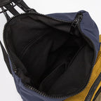 Open bag showing black interior with blue and yellow exterior