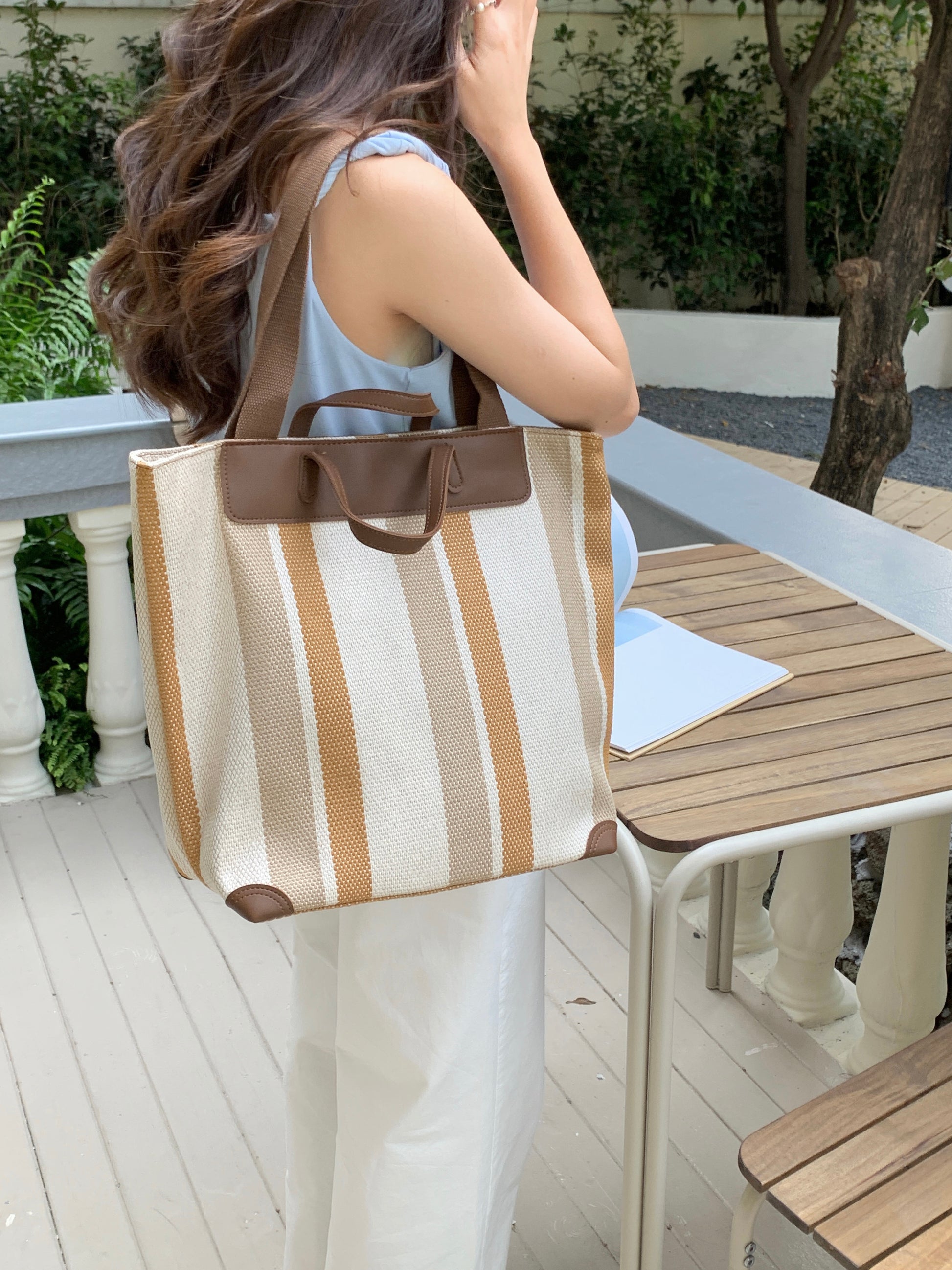 "Eco-friendly striped jute tote bag with dual handles – featuring bold black, grey, and white vertical patterns with leather-look accents and brown straps. Ideal for shopping, office, and casual outings. A sustainable and stylish choice from Tales of Totes – offering earthy, durable fashion accessories that stand apart from brands like Chumbak, Baggit, and DailyObjects in the Indian market."

