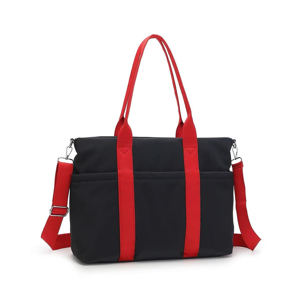 Black handbag with red straps on a white background
