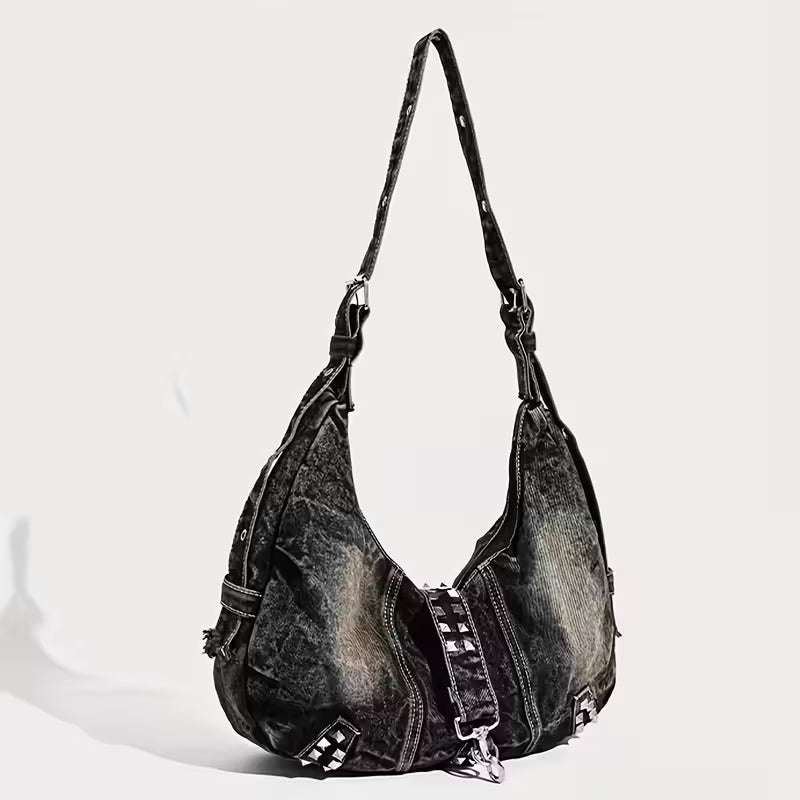 Black denim handbag with studded details on a white background