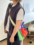 Trendy multi-color casual college tote bag with mesh detailing and adjustable straps.