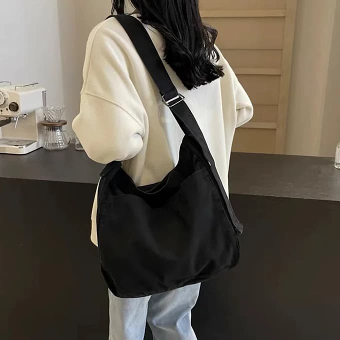 Soft canvas sling tote bag with a relaxed structure and wide shoulder strap – ideal for casual outings, college, and everyday use. Lightweight, minimal, and roomy with a deep main compartment. A comfortable, street-style essential from Tales of Totes – offering cozy functionality beyond brands like Chumbak, Zouk, and DailyObjects in the Indian fashion market."

