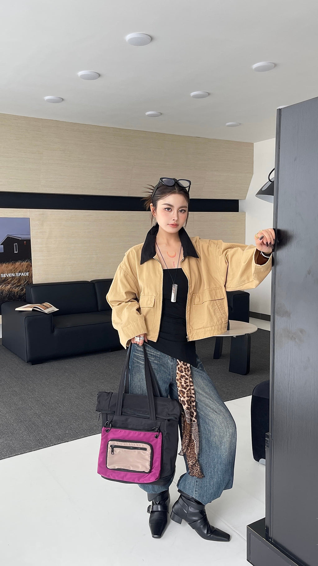 Woman holding a pink bag in an indoor setting