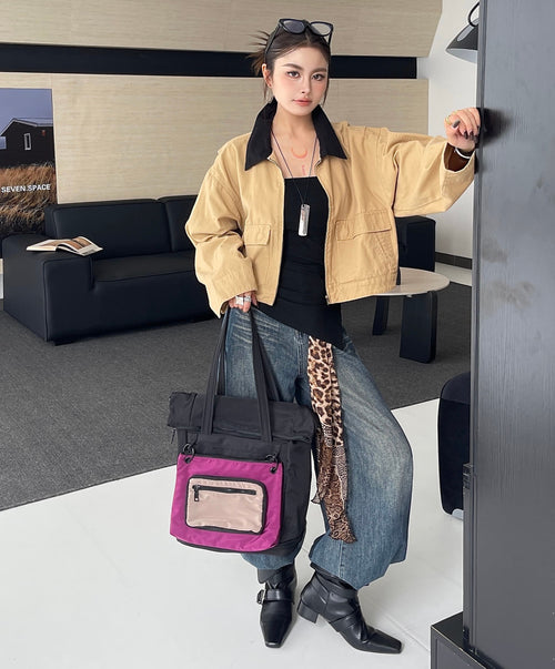 Woman holding a pink bag in an indoor setting
