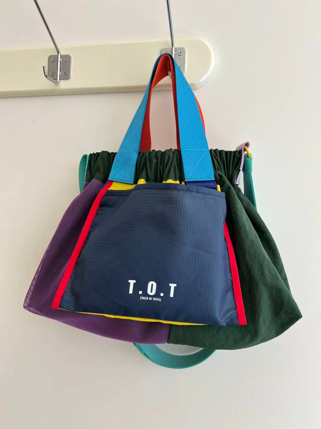 Trendy multi-color casual college tote bag with mesh detailing and adjustable straps.