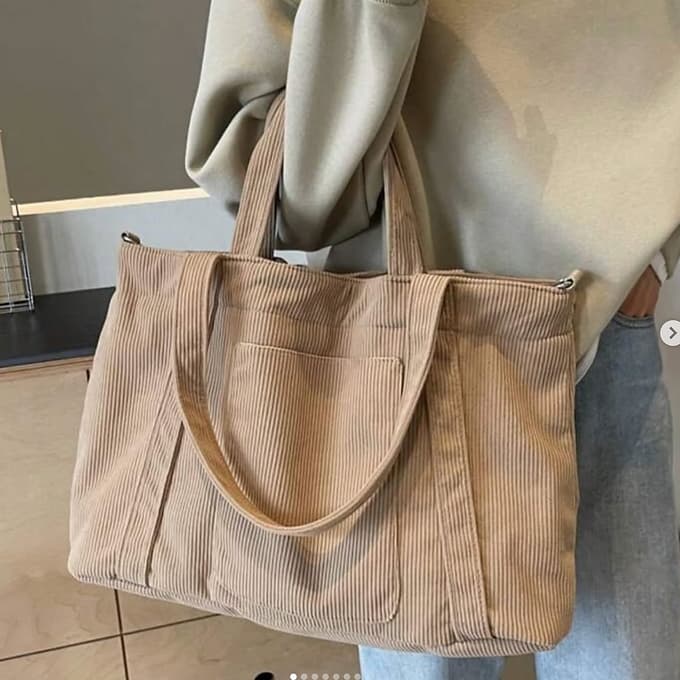 Trendy corduroy tote bag with dual handles and adjustable crossbody strap – soft-textured, oversized, and perfect for college, shopping, or everyday carry. Lightweight yet spacious, offering a casual streetwear aesthetic. A fashionable alternative from Tales of Totes – elevating Indian accessory trends beyond Zouk, Chumbak, and DailyObjects."

