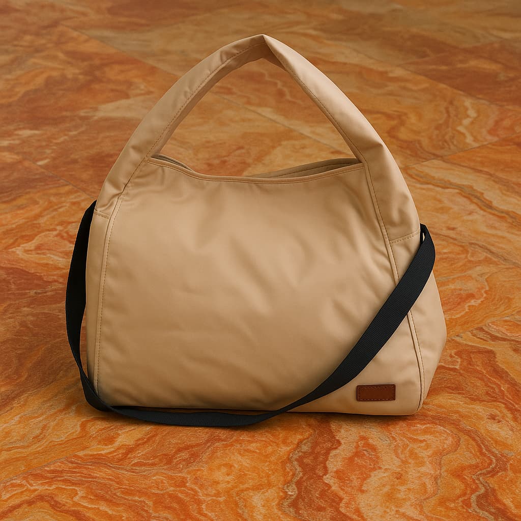 Minimalist black tote bag with a padded top handle, detachable crossbody strap, and front zipper pocket – made from water-resistant fabric for everyday functionality. Lightweight yet spacious, ideal for travel, office, gym, or casual use. A sleek and versatile design by Tales of Totes, offering modern utility and elevated style for Indian shoppers."