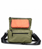 Green shoulder bag with a pink interior on a white background