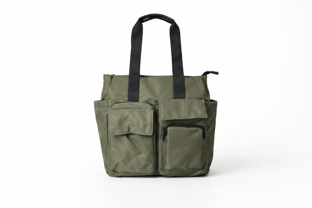 Green tote bag with black handles on a white background