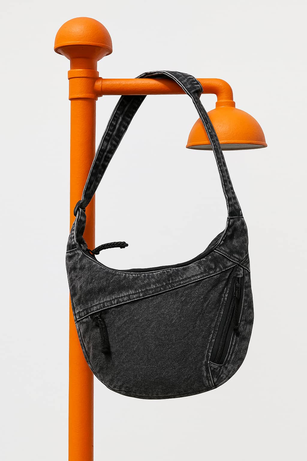 Unisex black denim sling tote bag with zip pocket, hanging on orange street pole, stylish and spacious for Indian streetwear

Affordable high-quality tote bag alternative to DailyObjects and Zouk, made for Indian fashion needs