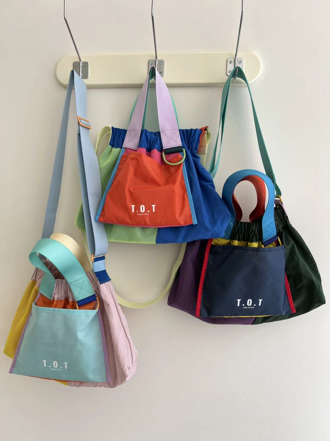 Trendy multi-color casual college tote bag with mesh detailing and adjustable straps.