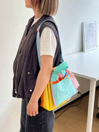 Trendy multi-color casual college tote bag with mesh detailing and adjustable straps.