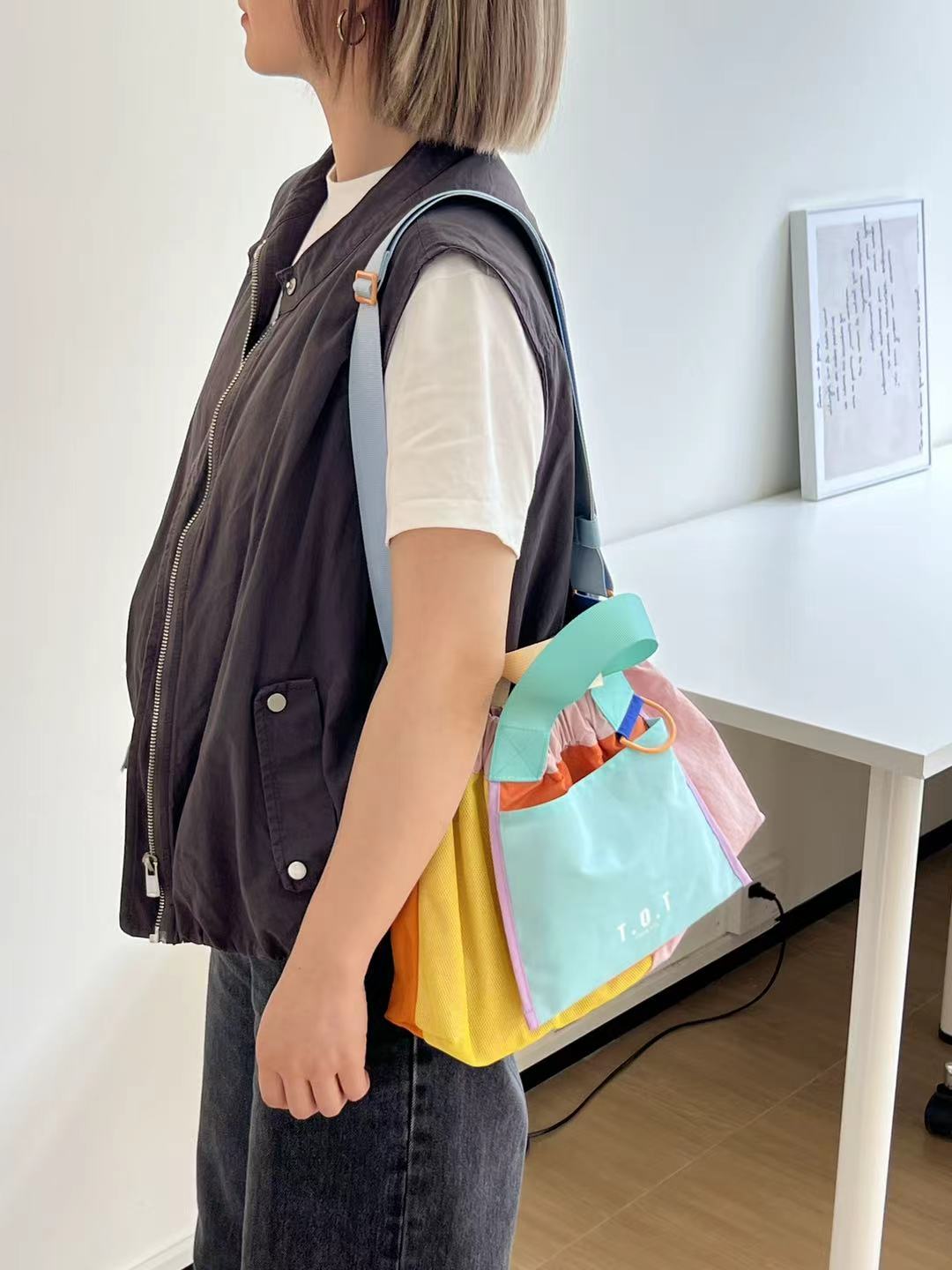 Trendy multi-color casual college tote bag with mesh detailing and adjustable straps.