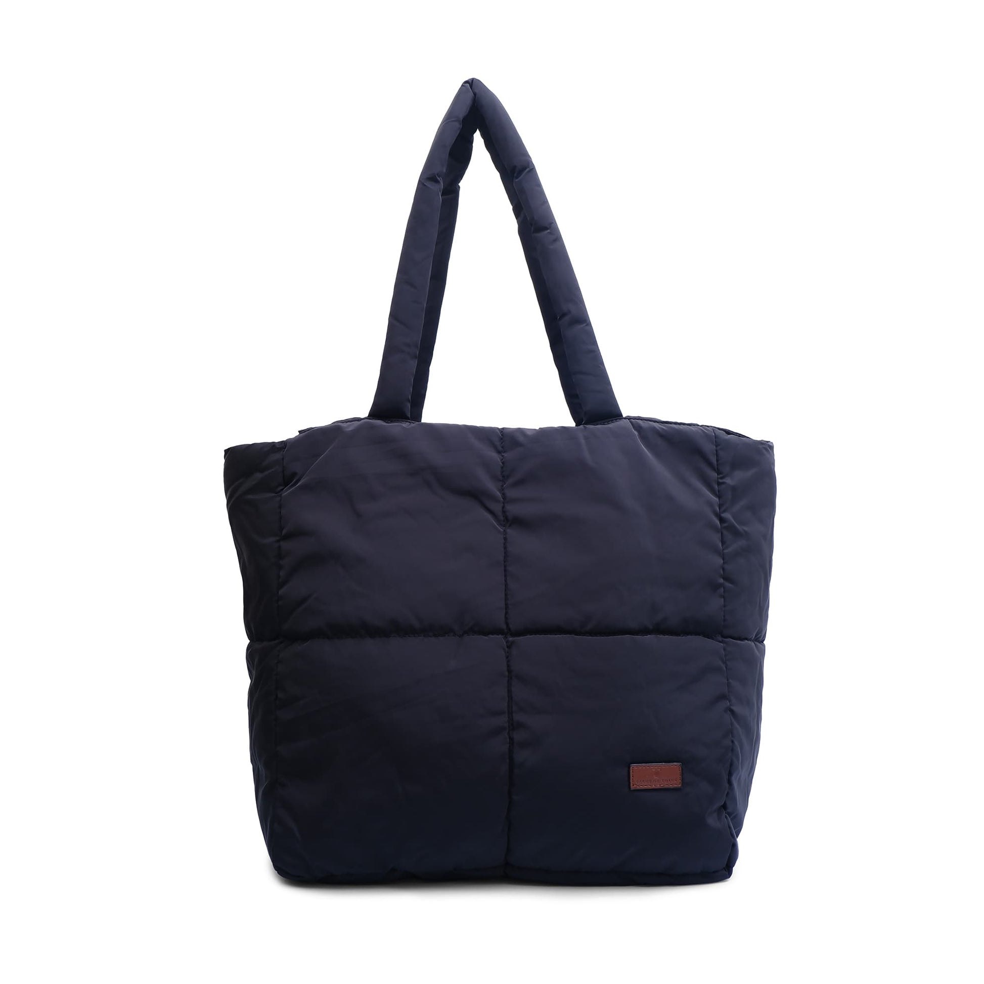 black puffer tote bag with a brown label on a white background,Quilted puffer tote bag with padded handles and a soft structured silhouette – lightweight, stylish, and perfect for daily use, college, travel, or shopping. Designed for comfort and statement appeal, this spacious carryall from Tales of Totes is a trendy alternative to Zouk, Lavie, and DailyObjects in India’s fashion accessories market."