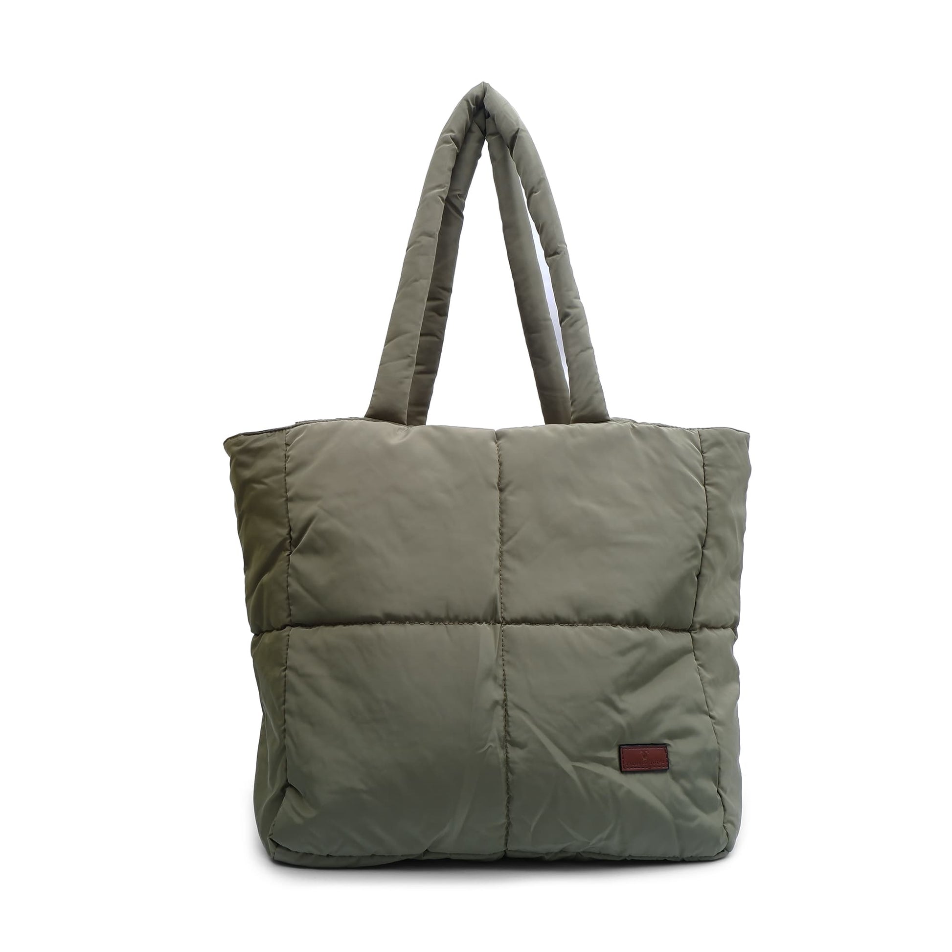 Green quilted tote bag on a white background Quilted puffer tote bag with padded handles and a soft structured silhouette – lightweight, stylish, and perfect for daily use, college, travel, or shopping. Designed for comfort and statement appeal, this spacious carryall from Tales of Totes is a trendy alternative to Zouk, Lavie, and DailyObjects in India’s fashion accessories market."