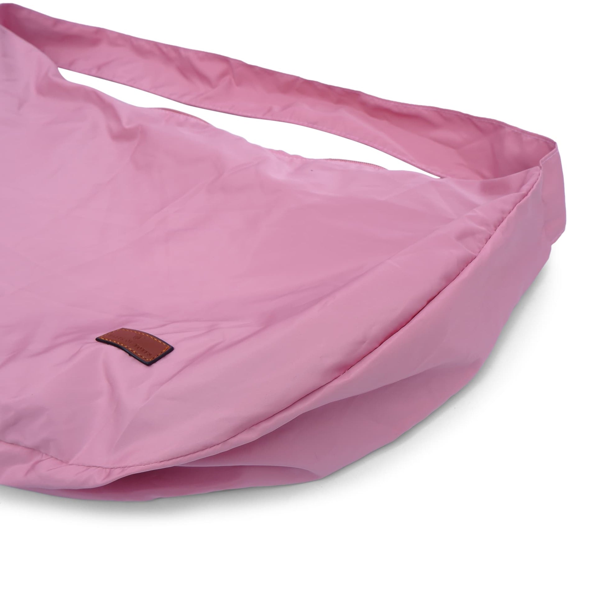 Half-moon shaped crossbody tote bag made from lightweight, water-resistant fabric – features a wide adjustable strap and secure top zipper closure. Minimalist design ideal for everyday carry, travel, or streetwear looks. A functional and fashion-forward piece from Tales of Totes, offering elevated casual utility for modern Indian shoppers."