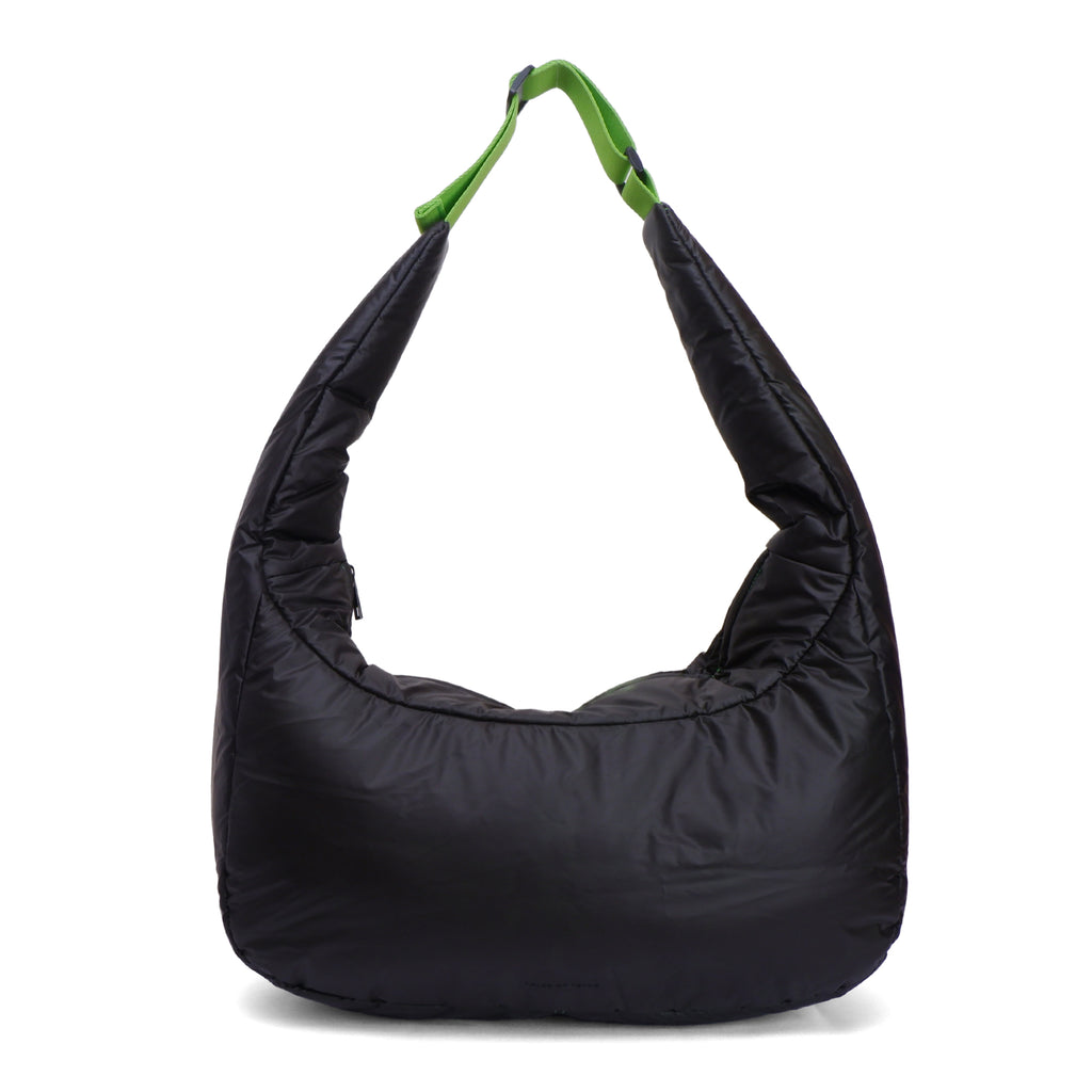 Black shoulder bag with a green handle on a white background