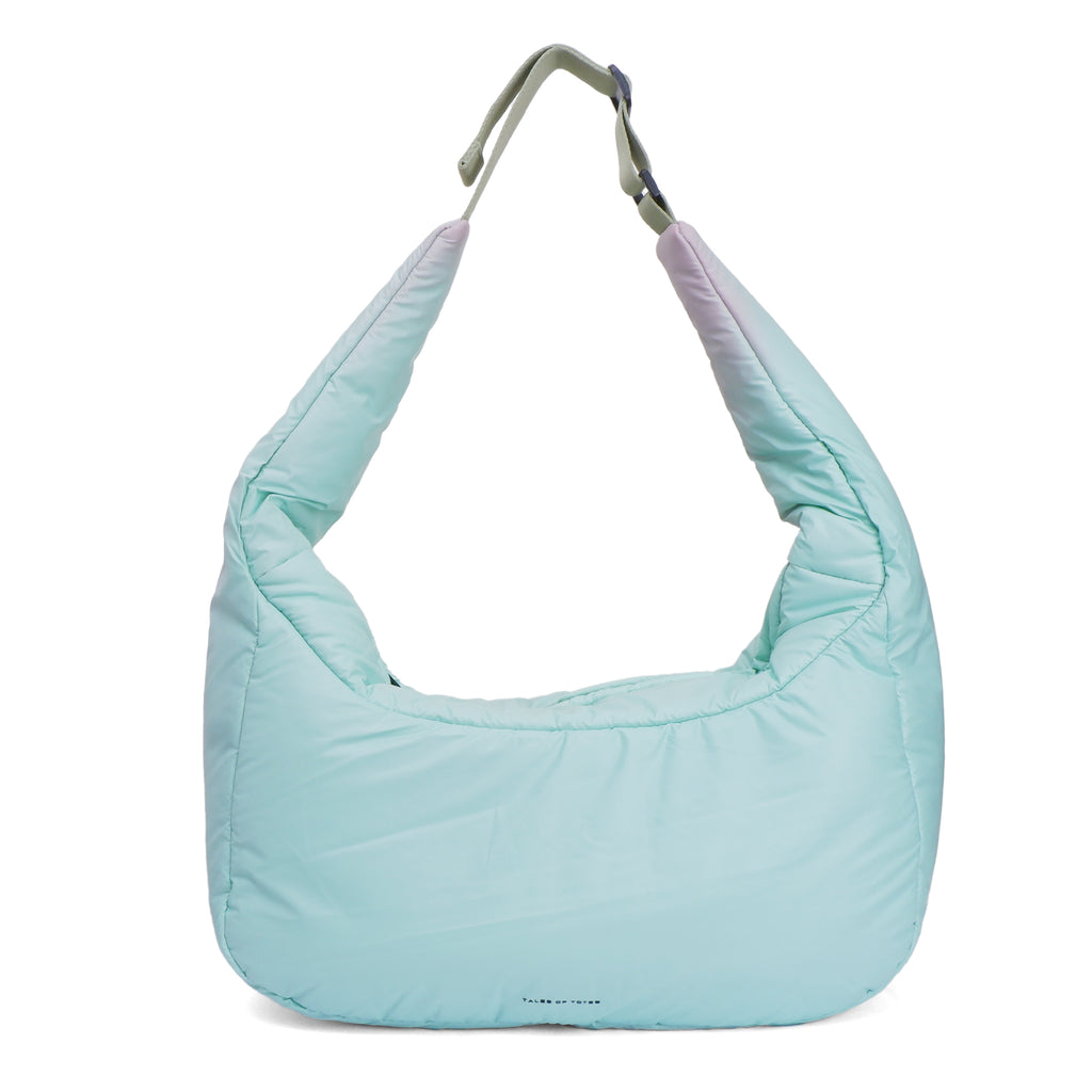 Light blue quilted handbag on a white background