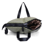 Green sleeping bag with black zipper and straps on a white background