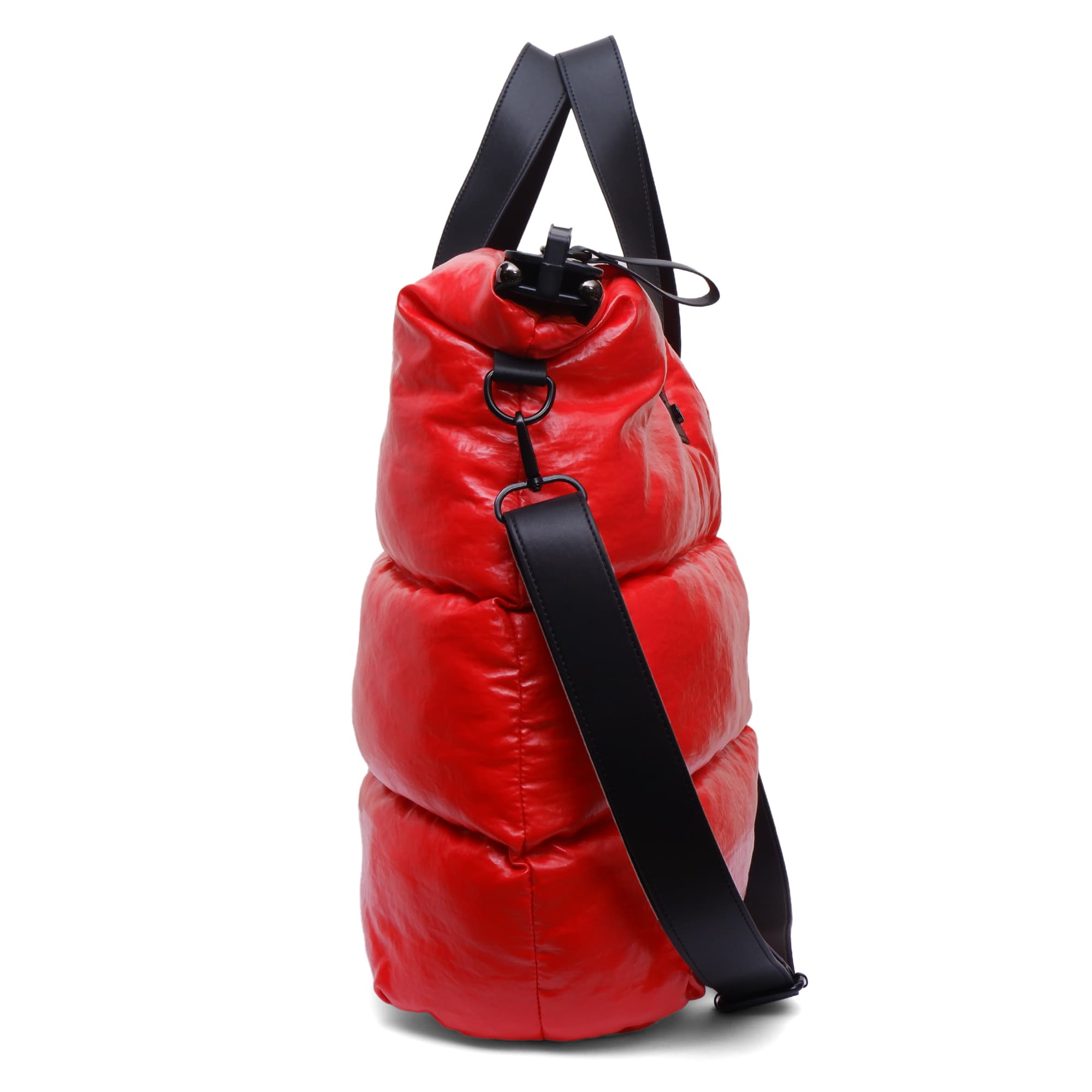 Red puffer bag with a black strap on a white background