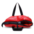 Red bag with black zipper and handle on a white background
