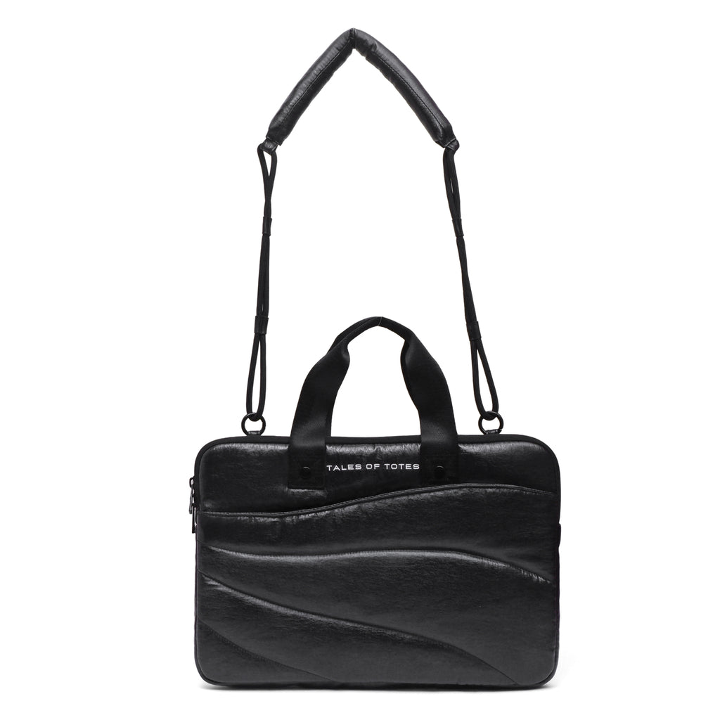 Black leather handbag with a strap on a white background