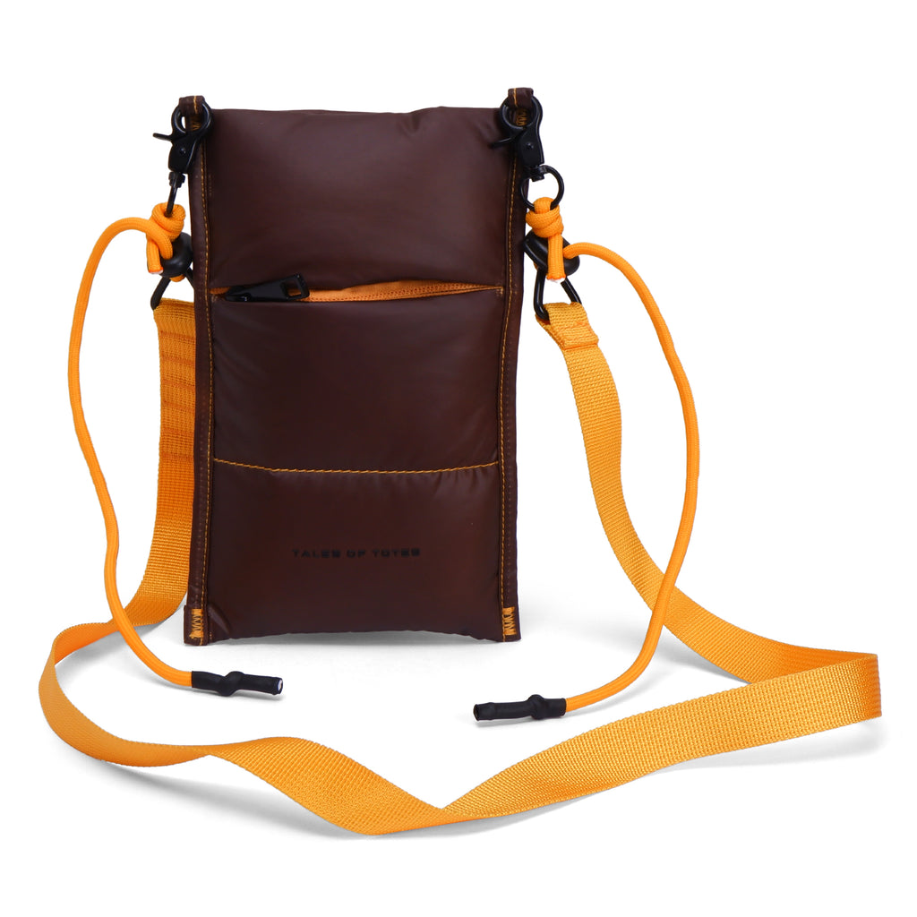 Brown crossbody bag with orange strap on a white background