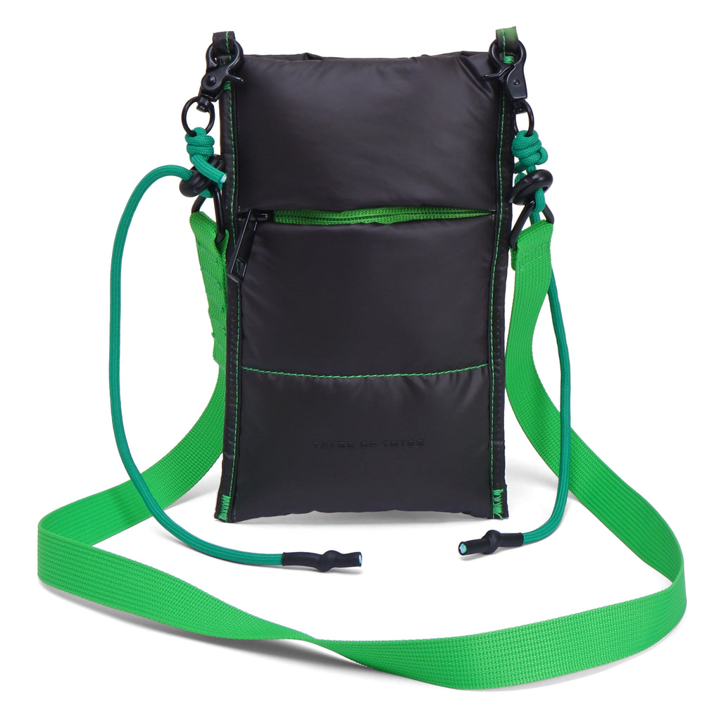 Black crossbody bag with green strap on a white background