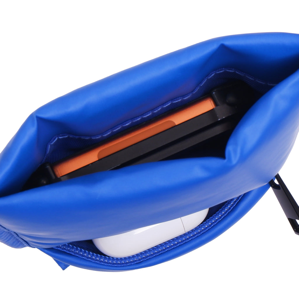 Close-up of blue earbud case with orange and black interior on a white background