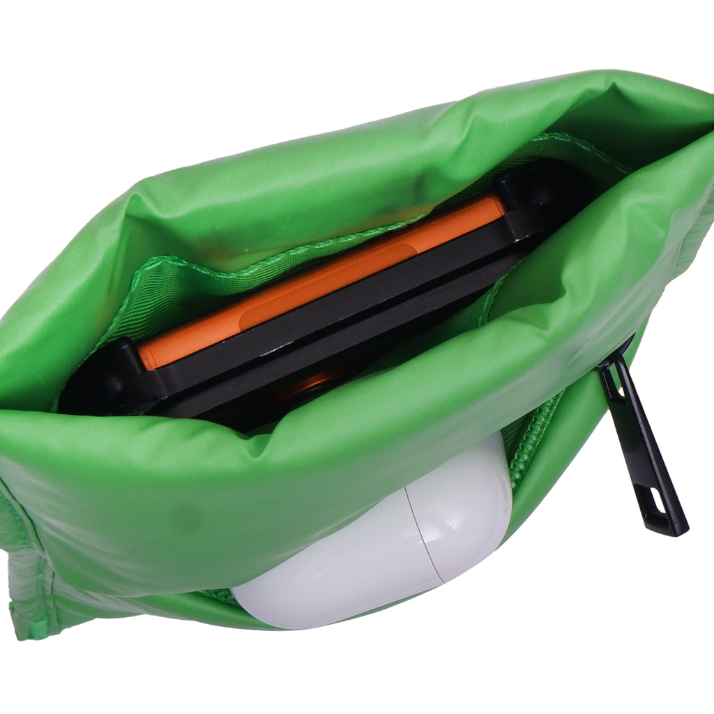 Green bag with a black and orange tool inside on a white background