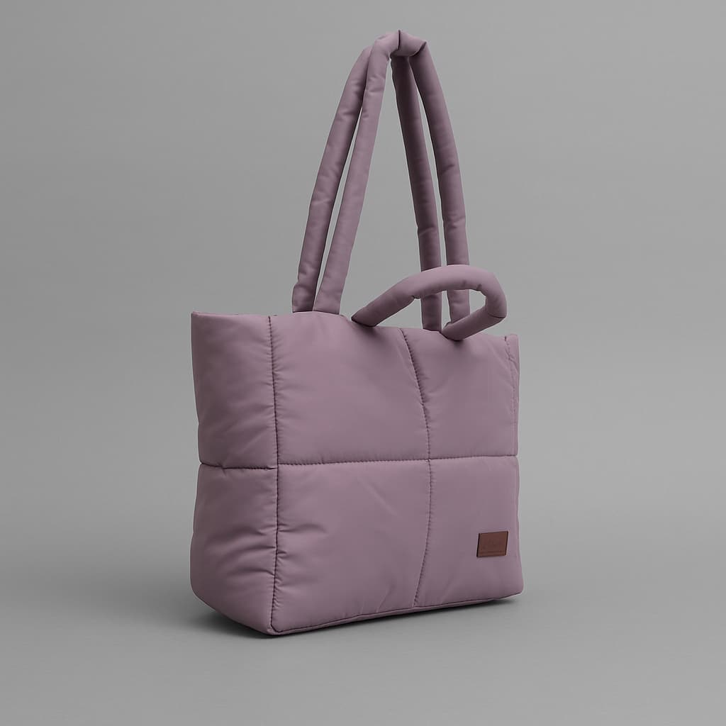 Stylish quilted puffer tote bag with padded handles and box-stitched detailing – ultra-lightweight, roomy, and perfect for everyday use. Ideal for college, shopping, or casual streetwear looks. A trendy fashion essential from Tales of Totes, offering cozy-chic appeal beyond standard canvas bags on Indian platforms like Myntra, Flipkart, and Amazon."