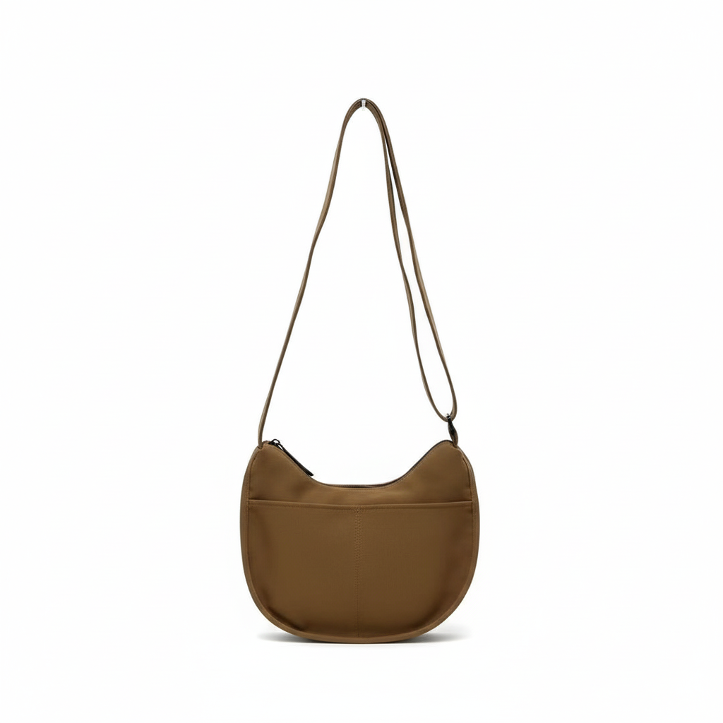 Brown shoulder bag on a white background,Trendy emerald green crescent half-moon shoulder bag for women, durable canvas, versatile for daily use, ethnic wear, and casual outings in India. This stylish sling bag offers a modern minimalist design, spacious interior, functioning as a chic carryall or small hobo tote.