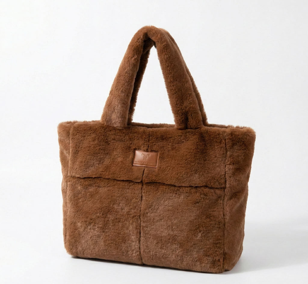 Brown fur tote bag with a leather patch on a white background
