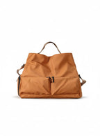 Brown backpack on a white background,A padded, water-resistant shoulder bag with a roomy interior, zip closure, and adjustable strap, designed for everyday carry and positioned as a stylish alternative to popular Indian brands like Zouk, Miraggio, Lavie, Caprese, and DailyObjects.
