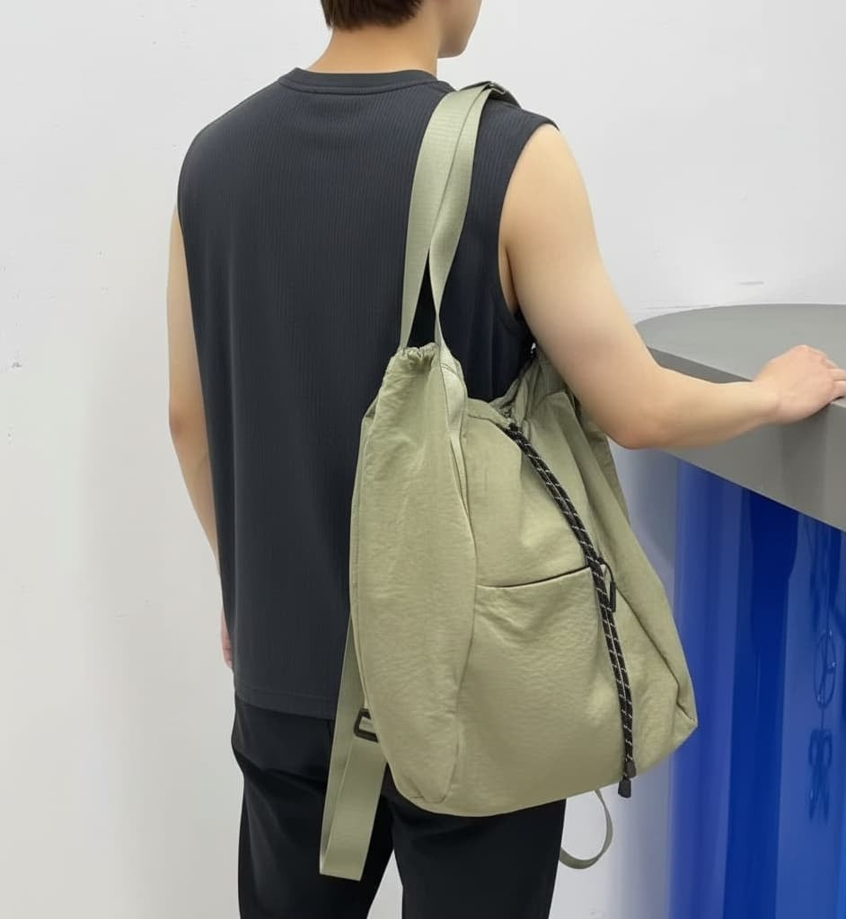 Person wearing a light green backpack against a plain background,Black backpack with drawstring on a white background,"Stylish khaki drawstring tote bag with multiple compartments and adjustable straps, perfect for daily use, shopping, and travel in India. Features include a secure zippered pocket, spacious main compartment, and comfortable shoulder straps. Ideal for fashion-conscious individuals seeking a versatile and trendy bag."