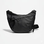 Black shoulder bag on a light gray backgroundA stylish, waterproof black nylon crossbody bag for men and women, perfect for travel, college, and daily use. Featuring a sleek design with multiple compartments, this unisex sling bag offers premium quality and durability. Ideal for the urban lifestyle, it's a versatile shoulder bag that blends fashion and function, making it a must-have accessory for trendsetters in India. #CrossbodyBag #NylonBag #SlingBag #UnisexFashion #TravelEssentials #CollegeBag #DailyUse