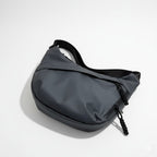 Gray waist bag on a light gray backgroundA stylish, waterproof black nylon crossbody bag for men and women, perfect for travel, college, and daily use. Featuring a sleek design with multiple compartments, this unisex sling bag offers premium quality and durability. Ideal for the urban lifestyle, it's a versatile shoulder bag that blends fashion and function, making it a must-have accessory for trendsetters in India. #CrossbodyBag #NylonBag #SlingBag #UnisexFashion #TravelEssentials #CollegeBag #DailyUseBag 
