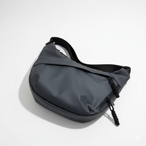 Gray waist bag on a light gray backgroundA stylish, waterproof black nylon crossbody bag for men and women, perfect for travel, college, and daily use. Featuring a sleek design with multiple compartments, this unisex sling bag offers premium quality and durability. Ideal for the urban lifestyle, it's a versatile shoulder bag that blends fashion and function, making it a must-have accessory for trendsetters in India. #CrossbodyBag #NylonBag #SlingBag #UnisexFashion #TravelEssentials #CollegeBag #DailyUseBag 