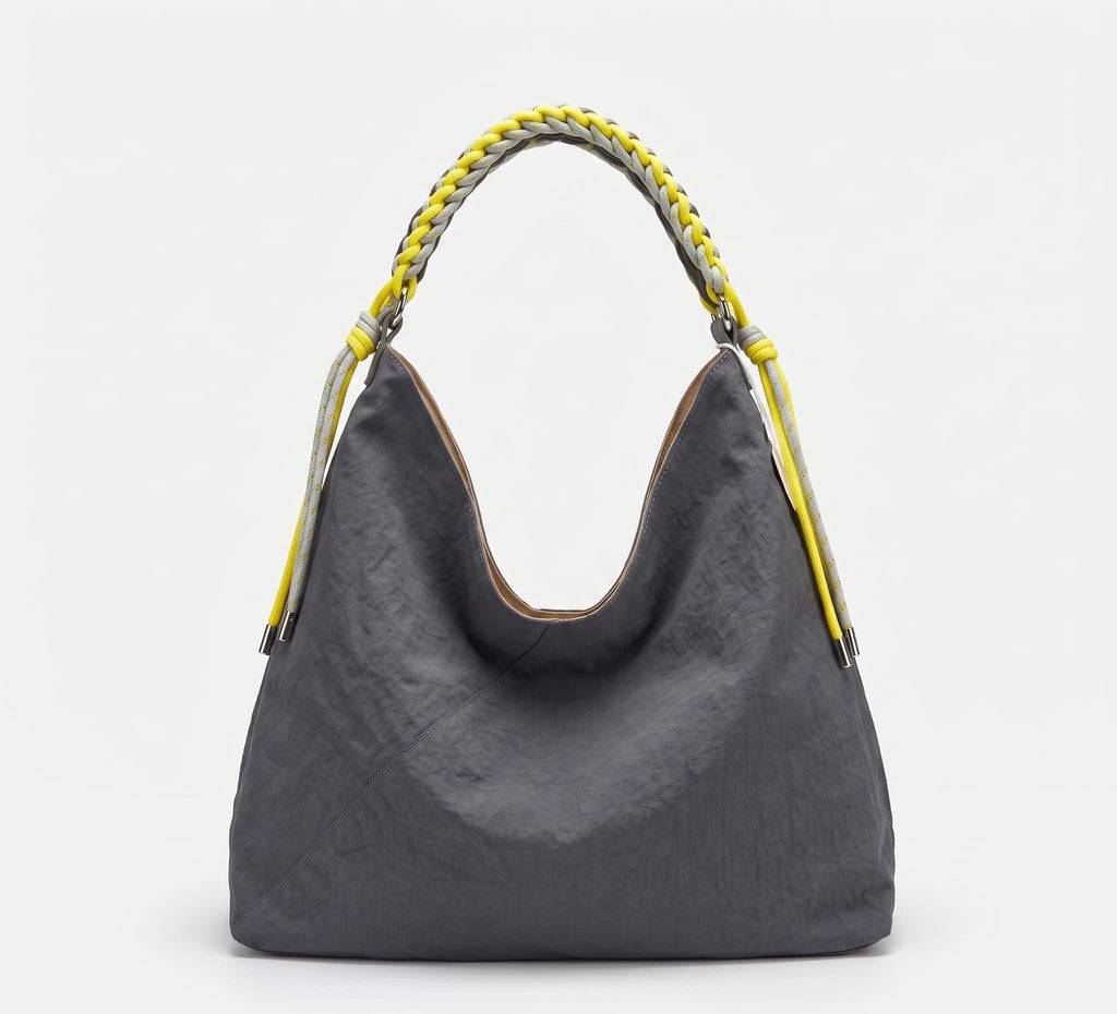A dark gray crinkled leather hobo bag with a braided yellow and gray shoulder strap, shown against a plain white background.