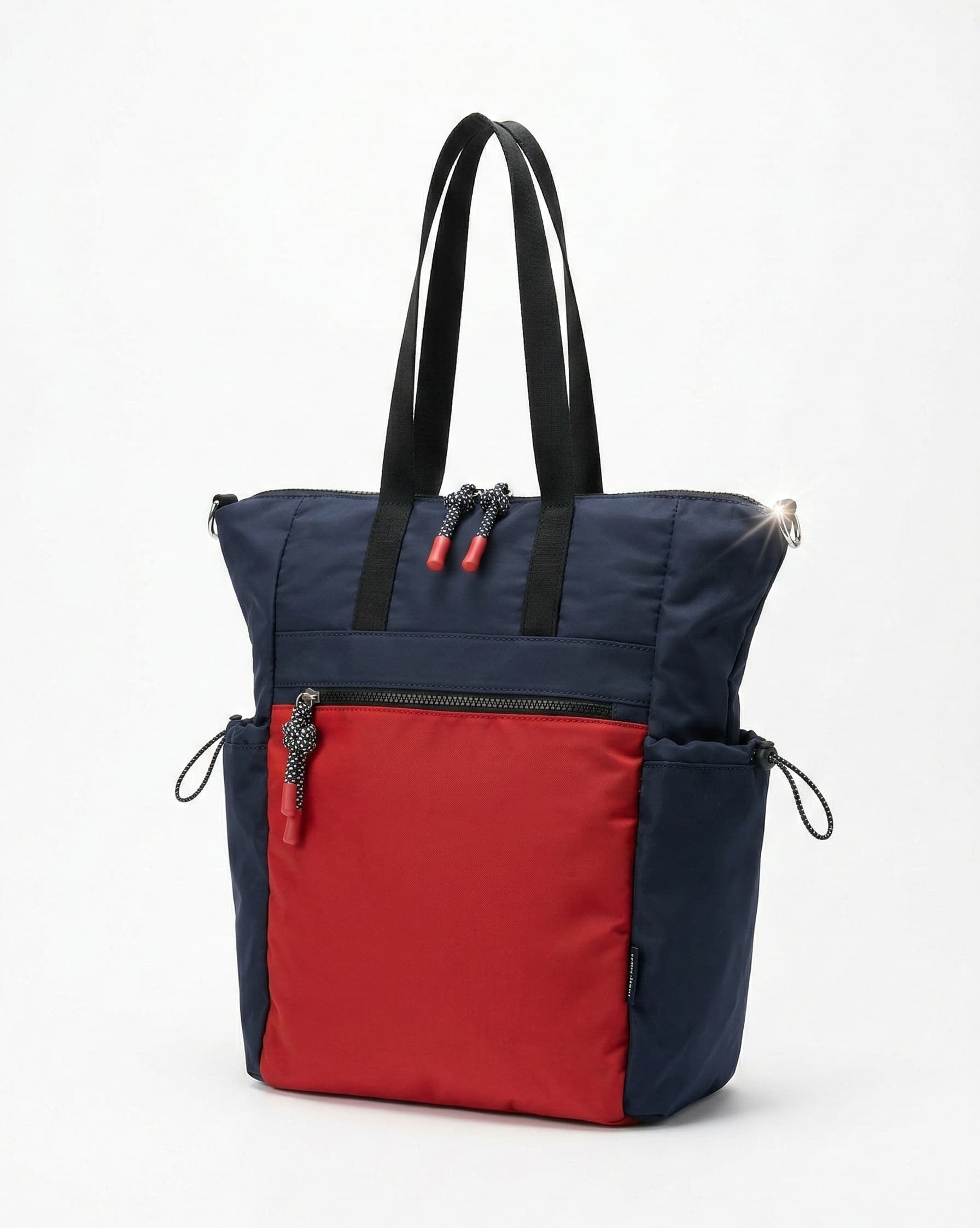 Navy and red tote bag with black handles on a white background