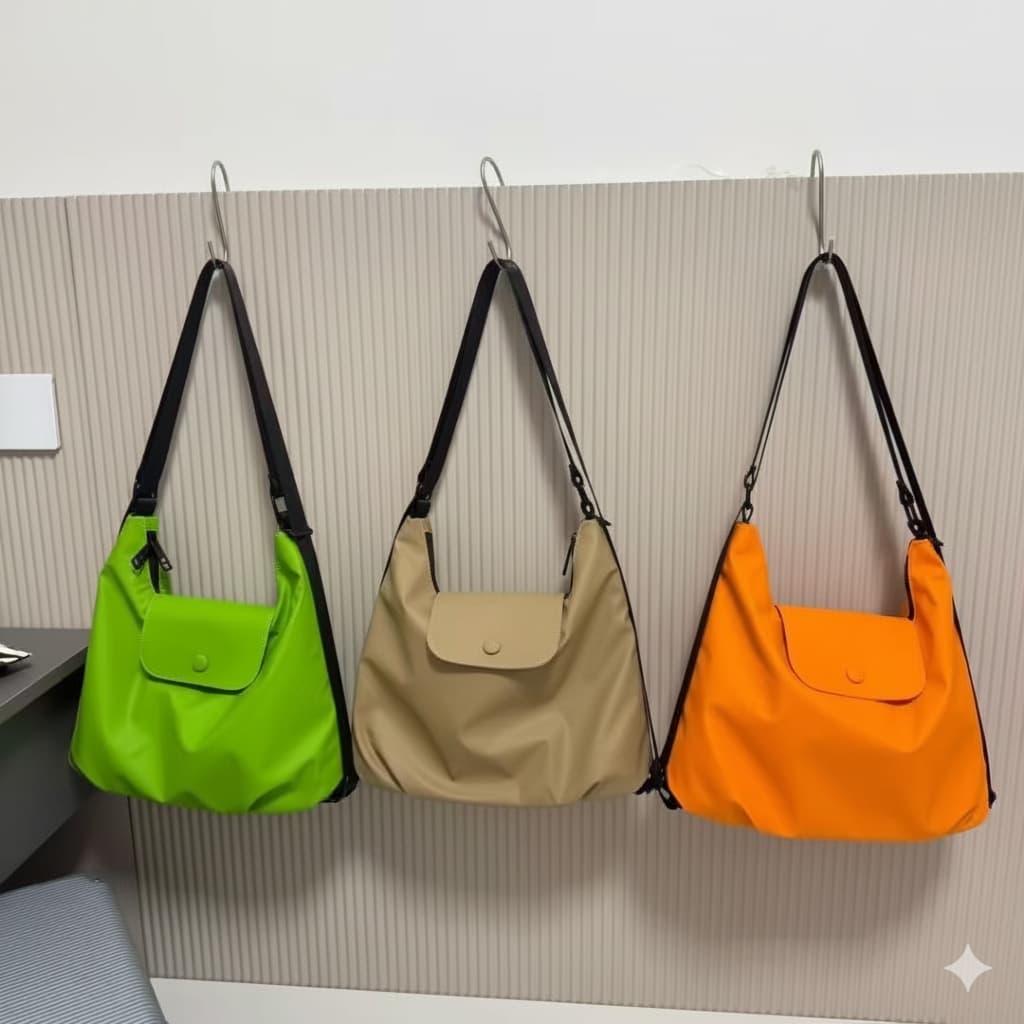 Three bags in green, beige, and orange hanging on a wall hook against a neutral background.laptop tote bag for women, tote bag for office use, college tote bag with zipper, and stylish bags for girls. You can also target users with specific needs by using long-tail phrases like vegan leather tote bag or tote bag for daily use in India. To understand the market better, keep an eye on competitors such as Lavie, Baggit, and Caprese, all of which are major players in the Indian handbag space, along with brands 