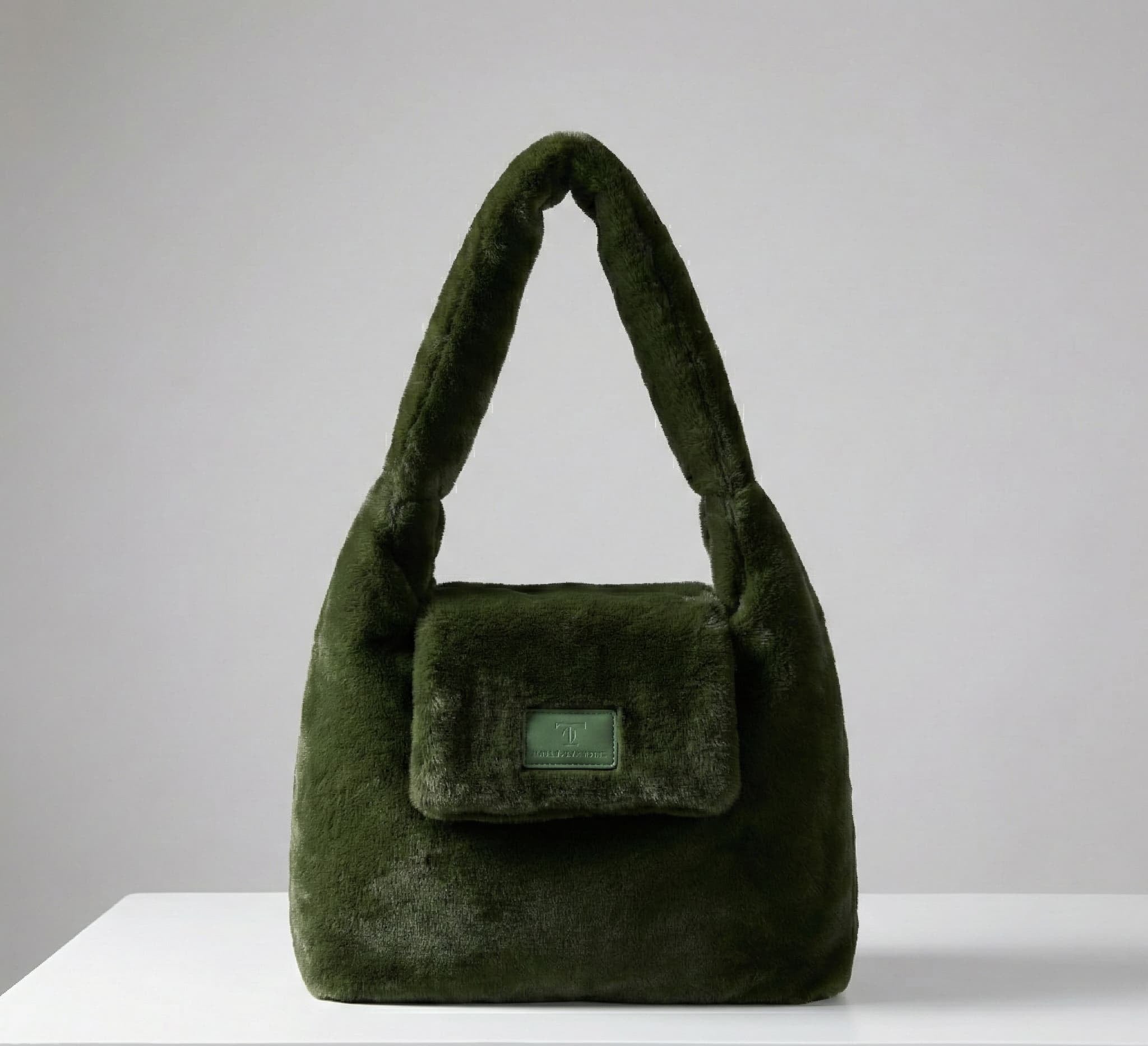 Green velvet handbag on a light gray background