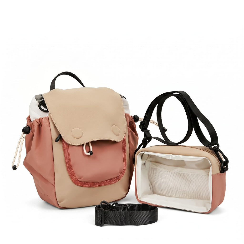 A two-tone backpack shown in closed and open views on a clean white background. The backpack features a beige flap with snap buttons and a dusty rose front pocket, with black straps and a matching black buckle strap laid in front.