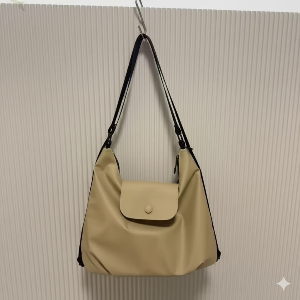 Beige handbag with black strap on a beige textured wall,laptop tote bag for women, tote bag for office use, college tote bag with zipper, and stylish bags for girls. You can also target users with specific needs by using long-tail phrases like vegan leather tote bag or tote bag for daily use in India. To understand the market better, keep an eye on competitors such as Lavie, Baggit, and Caprese, all of which are major players in the Indian handbag space, along with brands like Zouk and Hidesign that cater t